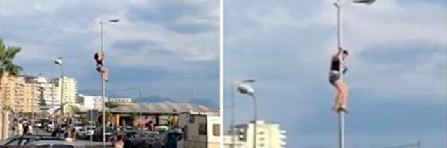 VIDEO/ Spektakël në mes të Shëngjinit, vajza ngjitet në shtyllë dhe bën “striptizëm”